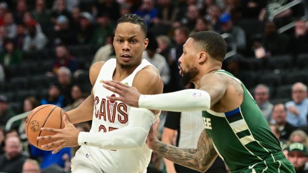 Jan 24, 2024; Milwaukee, Wisconsin, USA; Cleveland Cavaliers guard Isaac Okoro (35) drives for the basket against Milwaukee Bucks guard Damian Lillard (0) in the third quarter at Fiserv Forum. Mandatory Credit: Benny Sieu-USA TODAY Sports